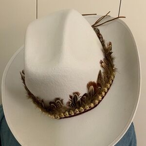 Feather hat band with brown braid and gold sculls.
